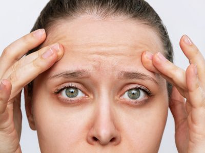 young-caucasian-worried-woman-touching-forehead-demonstrating-wrinkles-her-face